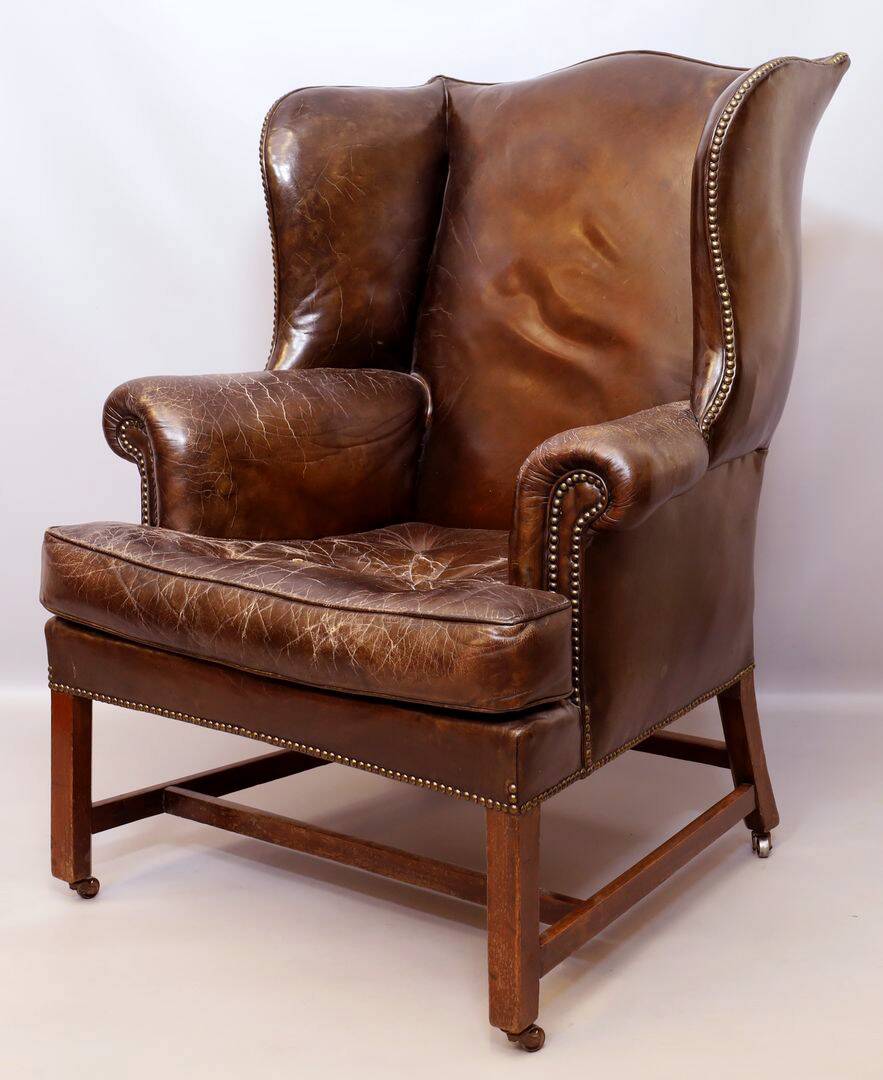 Wingback armchair in dark brown patinated leather, 1970s