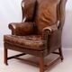 Wingback armchair in dark brown patinated leather, 1970s