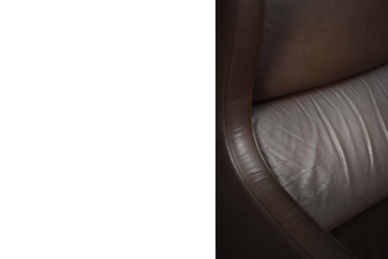 Brown leather wingback chair in mid-century modern Danish style, 1960s.