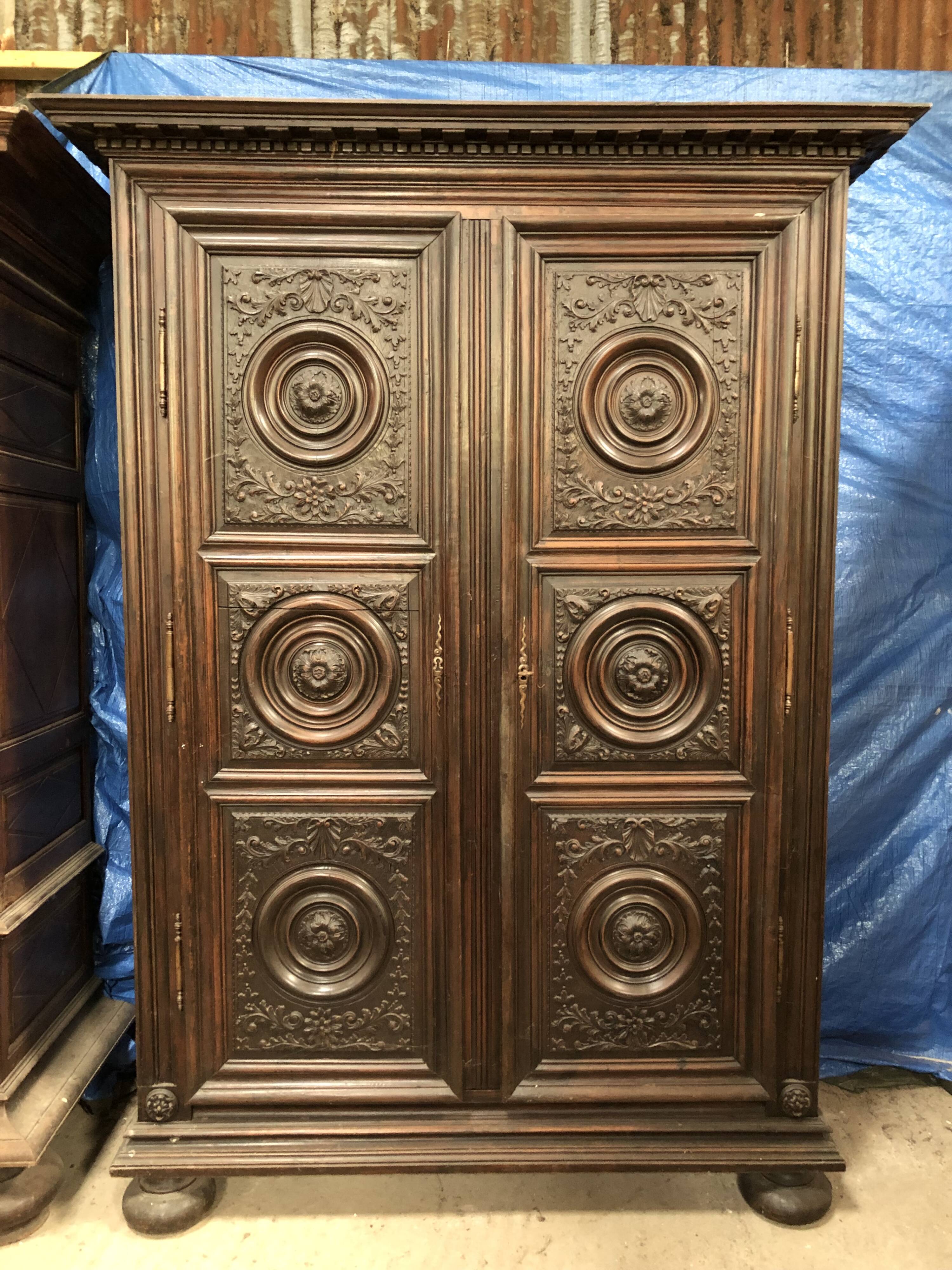 Antique Louis XIII armoire in solid walnut with carved doors