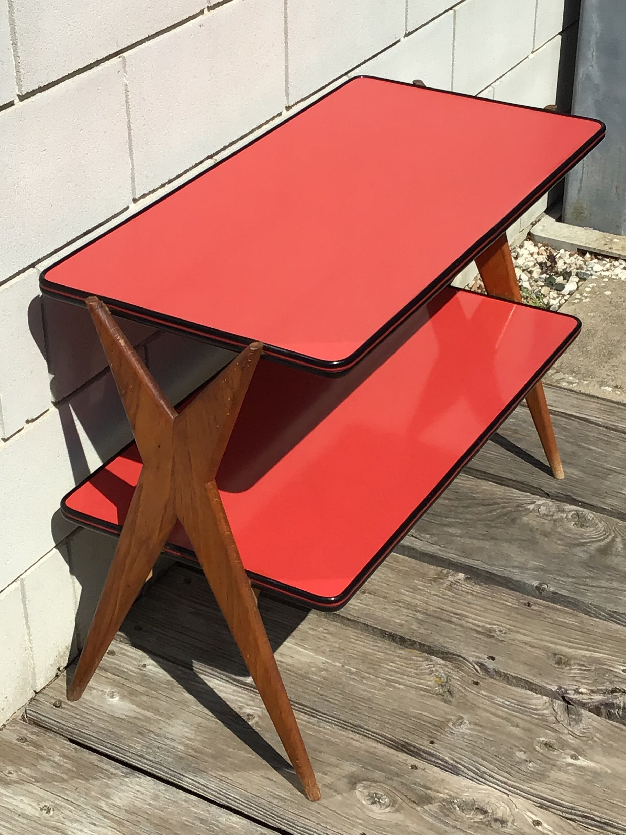 Double-footed red Formica wood spindles console