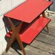 Double-footed red Formica wood spindles console