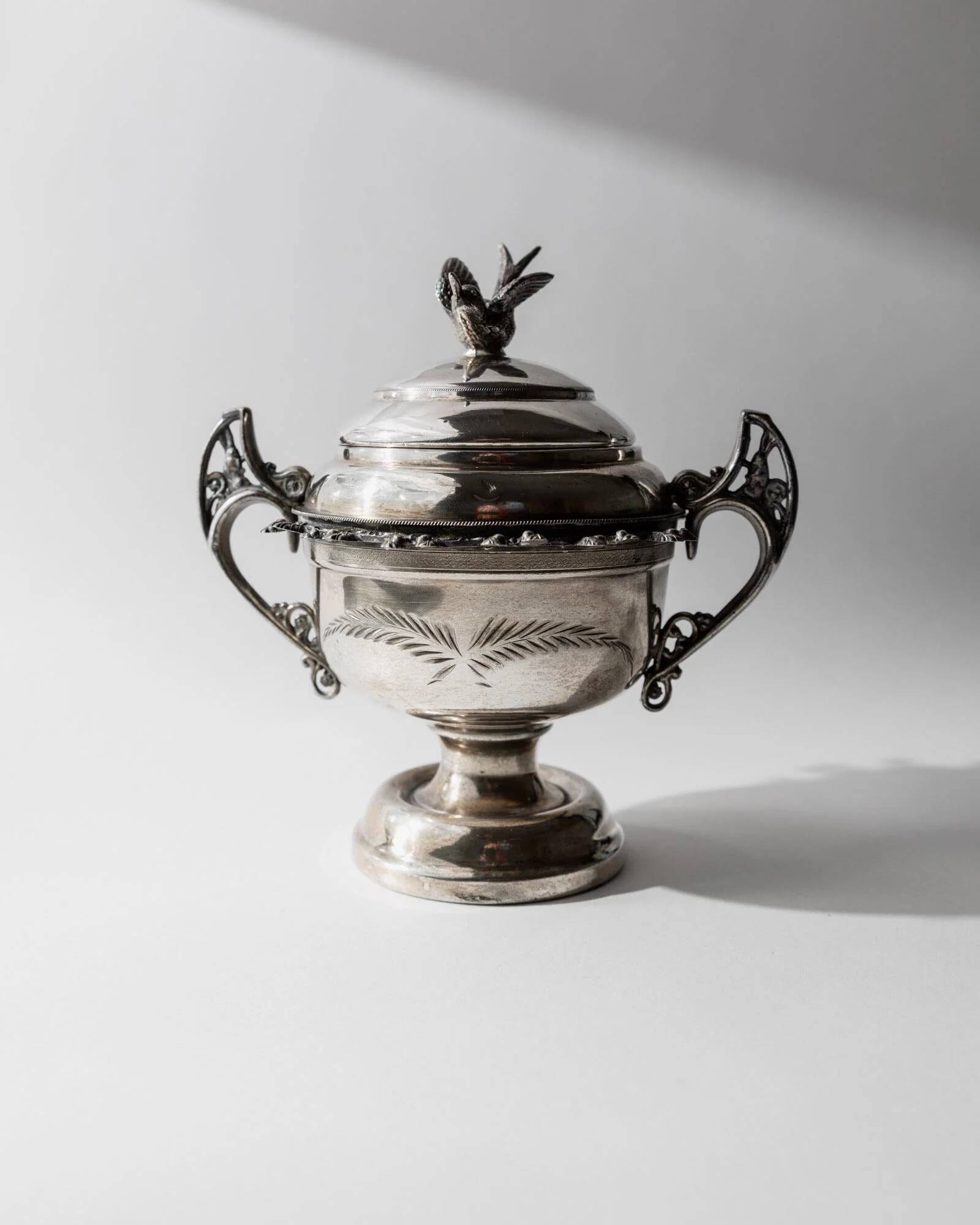 Vintage 1930s silver-plated footed bowl with lid by Warren Rogers New York, featuring a bird motif and ornate details.