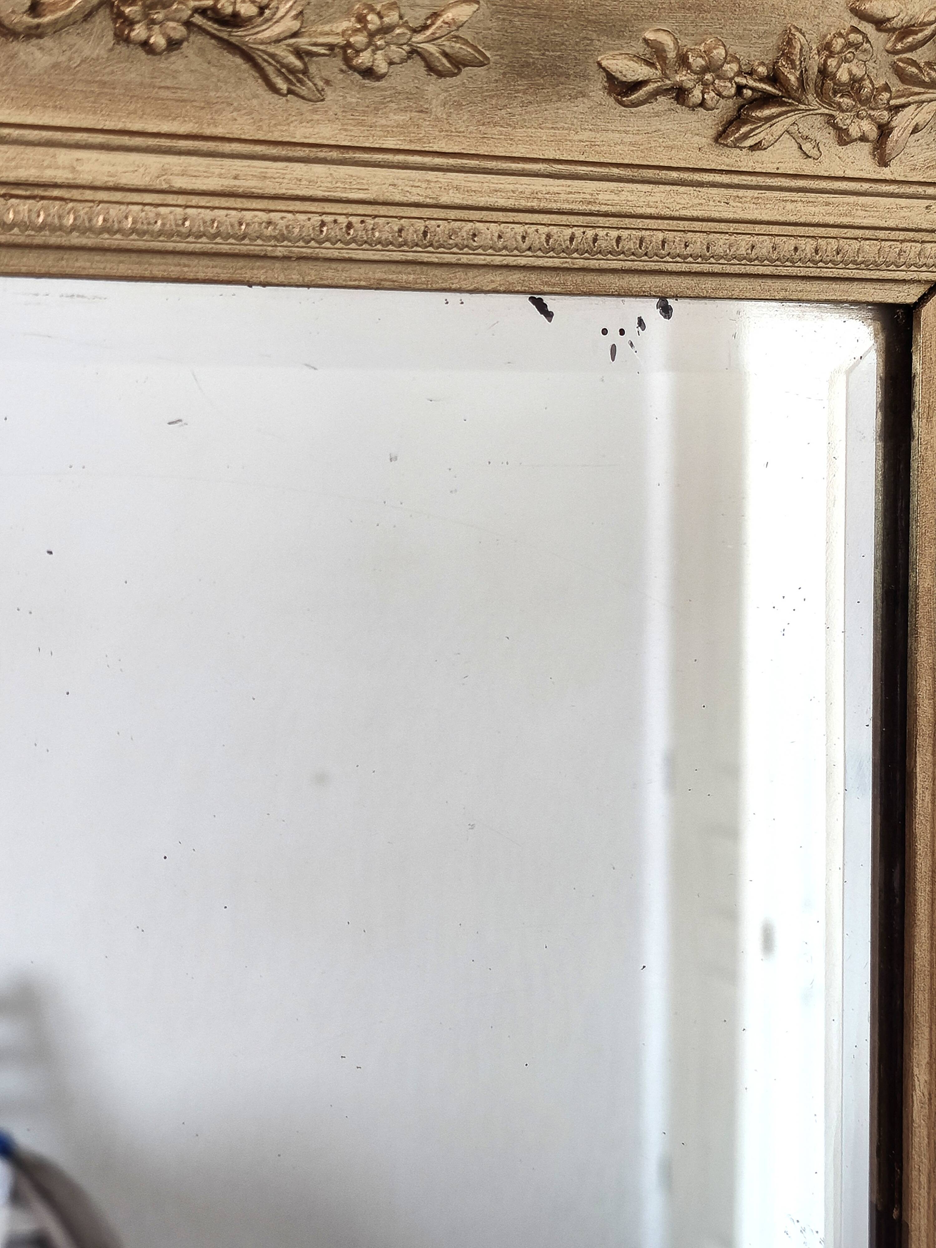 Richly carved antique gilded mirror