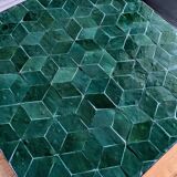 A pair of wrought iron side tables with emerald green Moroccan zellige.