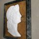 Profile of a young man in the style of antique marble.
