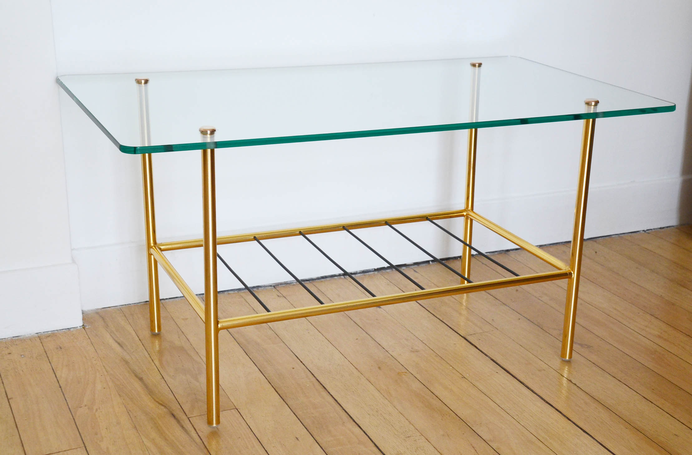 Glass coffee table with magazines holder