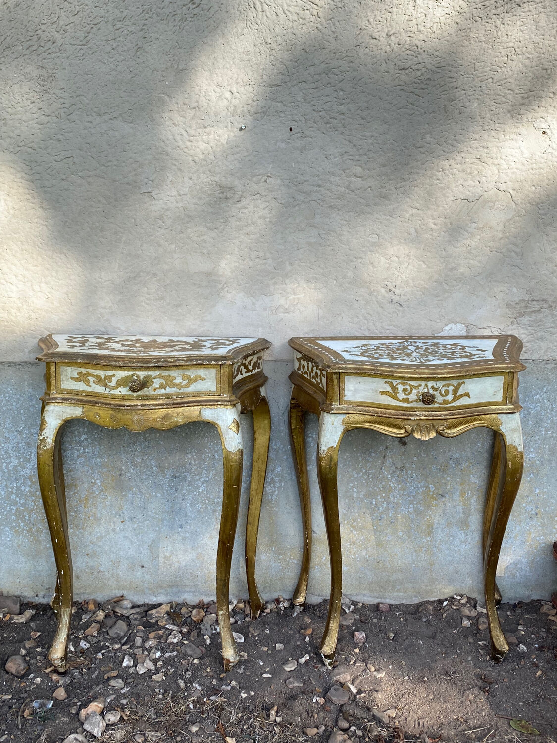 Pairs of Florentine bedside tables in gilded wood.