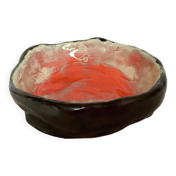 Ceramic tray in orange, white, and black.