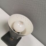 Small stylish table lamp with perforations and milky white opal glass shade