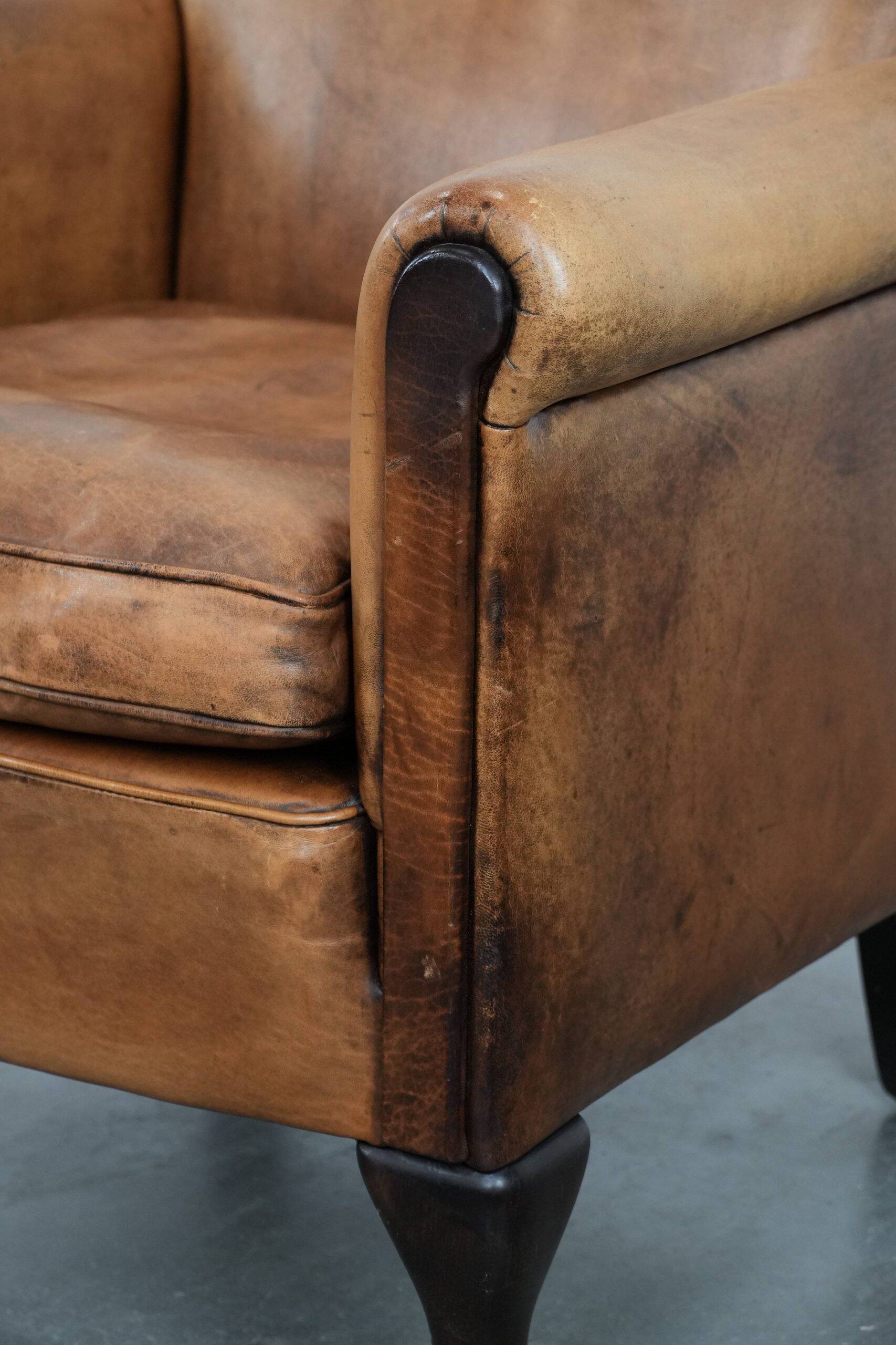 Vintage sheepskin armchair with a beautiful light colour and elegant legs