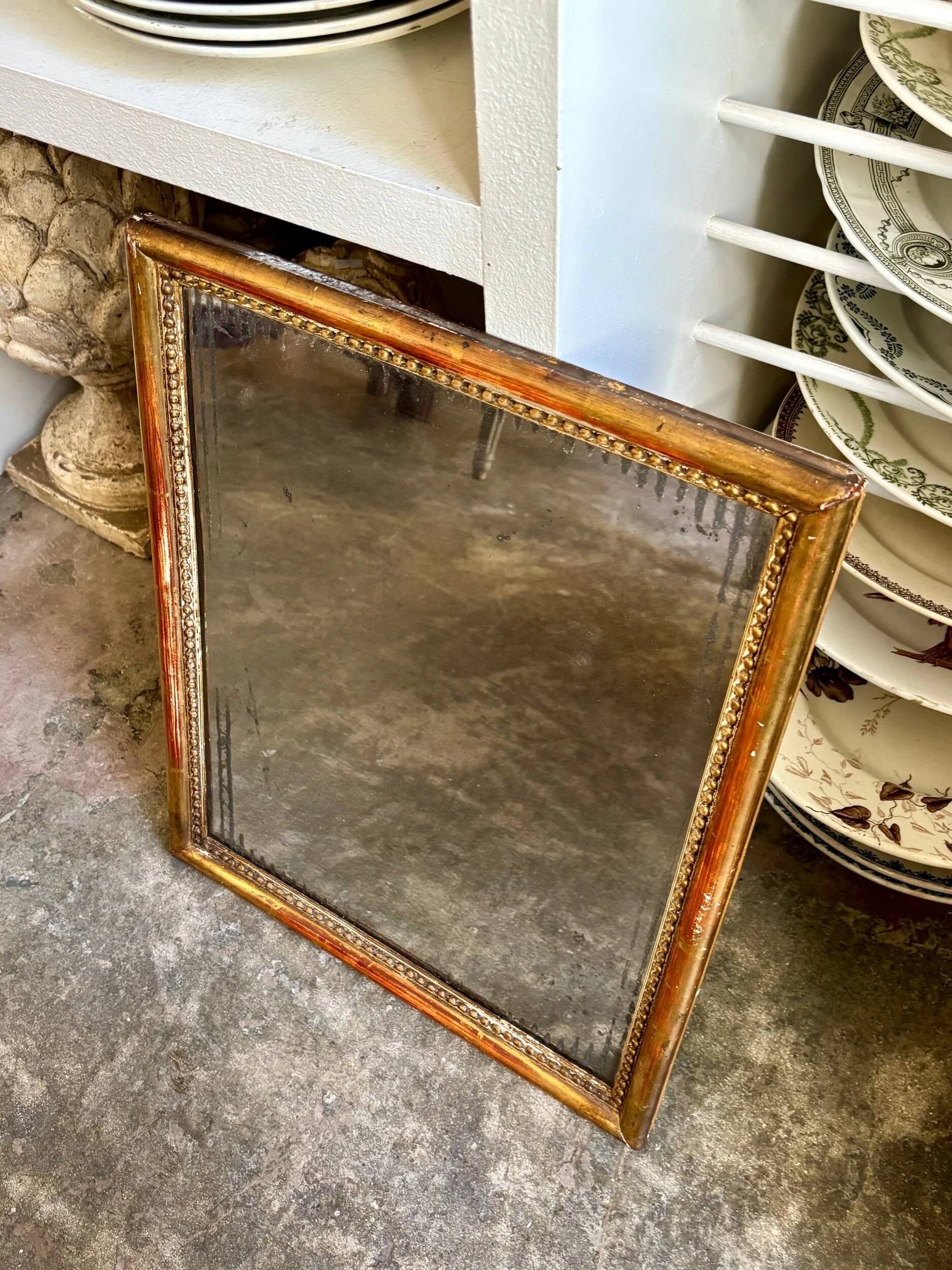 Wooden mirror with gilded stucco and beaded frieze, 45 x 37 cm