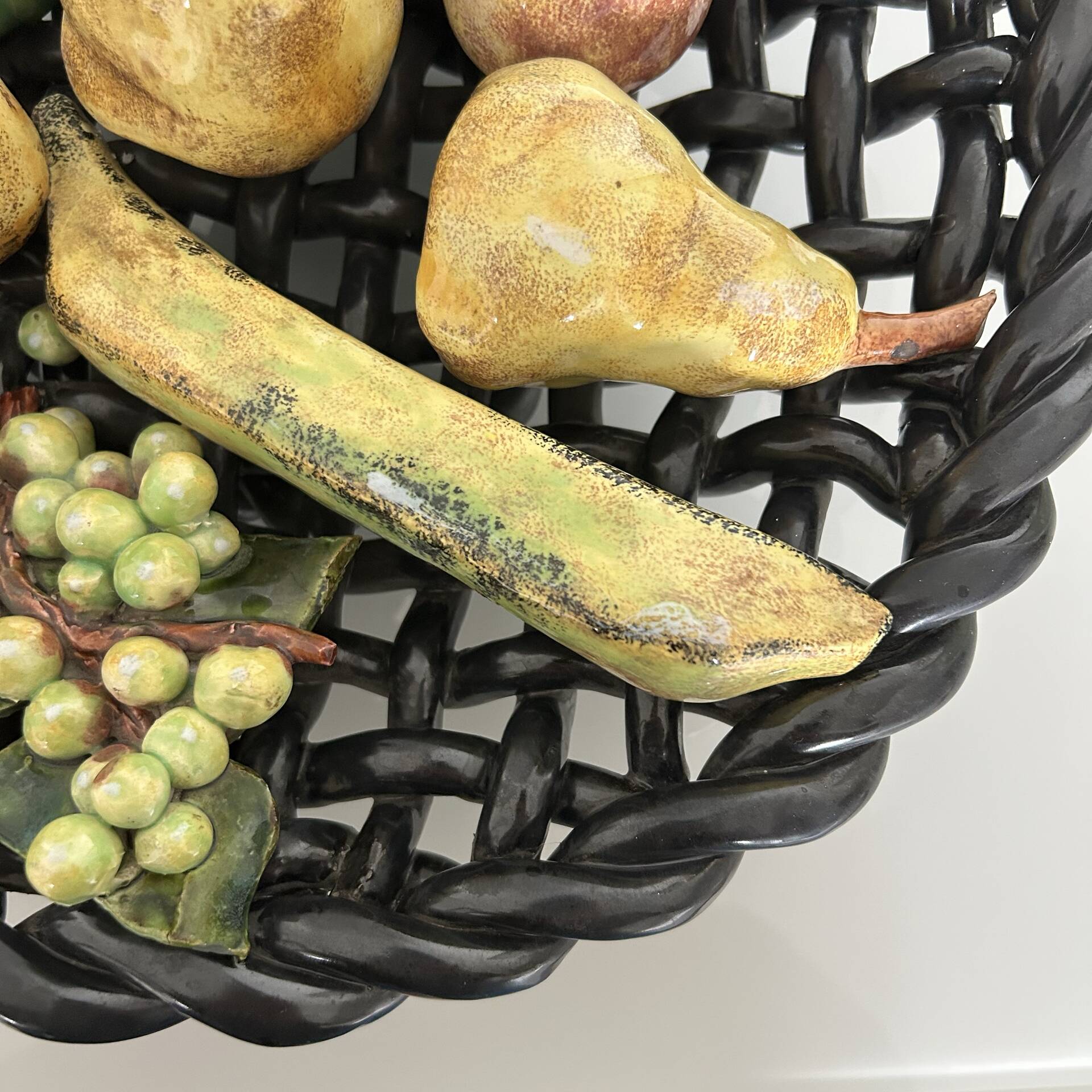 Large woven bowl and trompe l'œil fruits