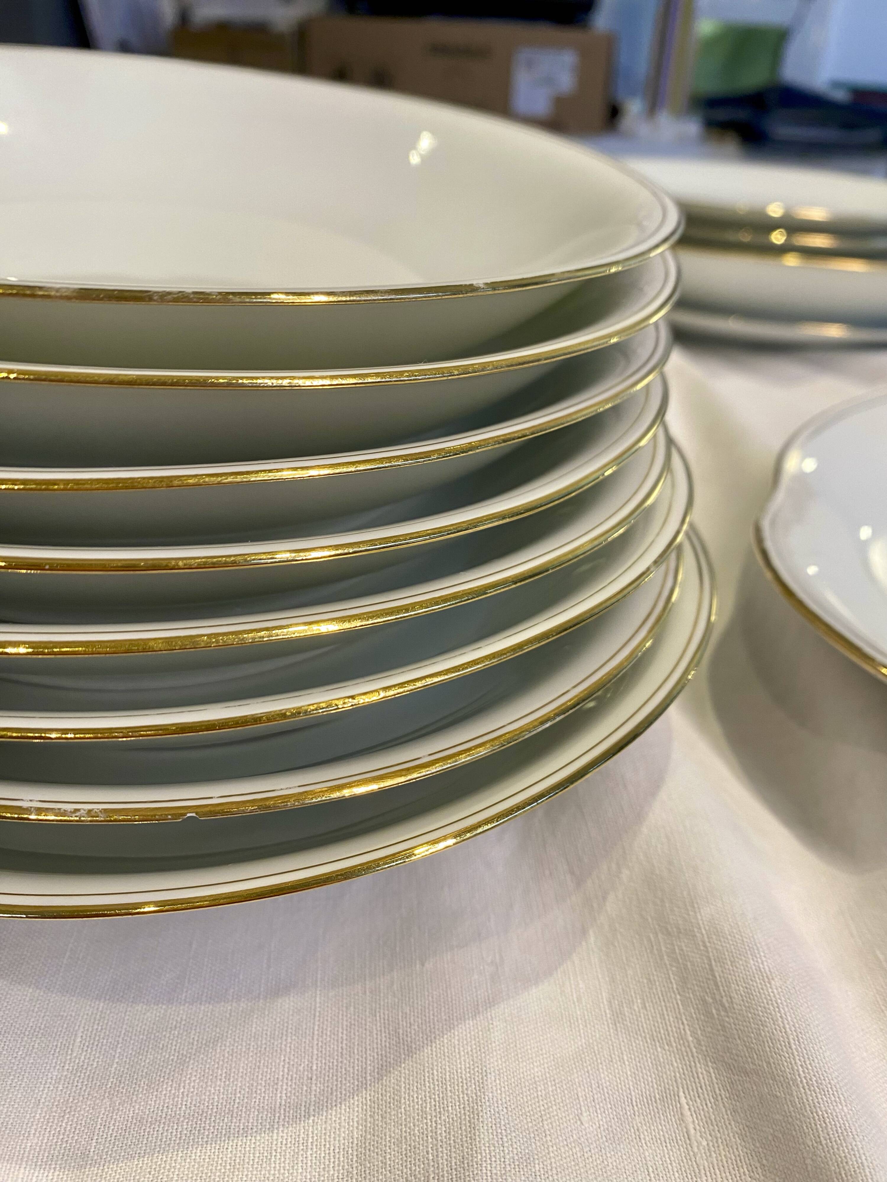 Vintage table service Limoges porcelain white with gold trim.