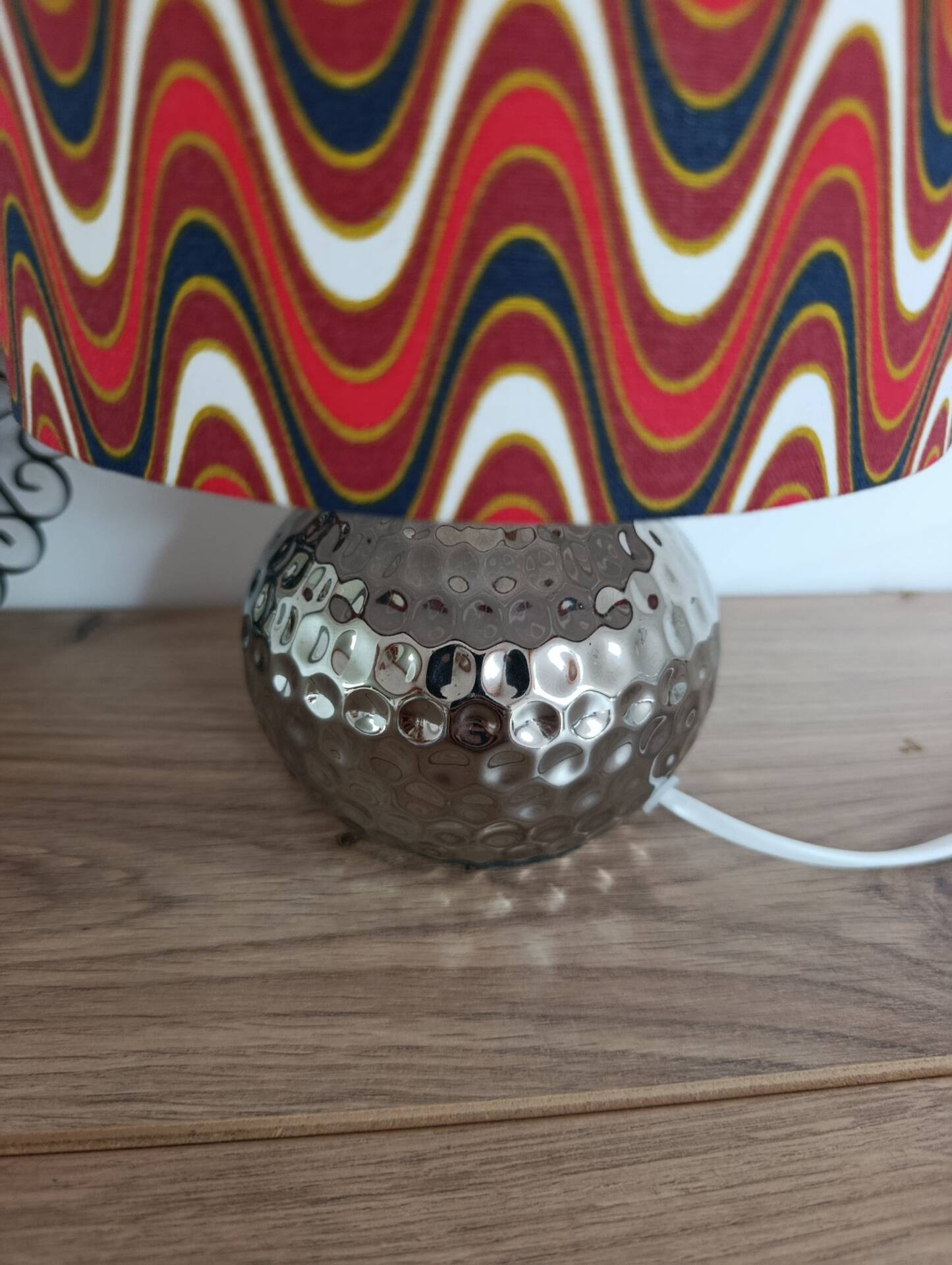 Vintage table lamp with printed shade featuring seventies waves.