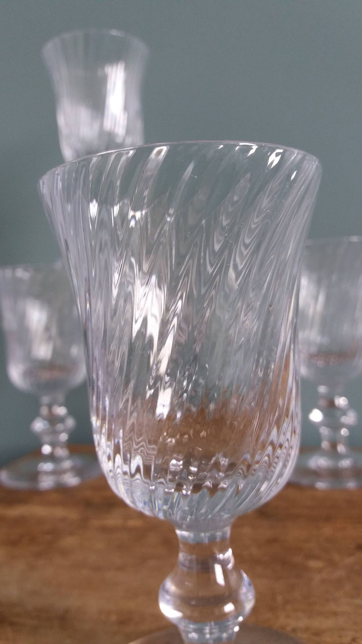 Ancient footed crystal glasses with relief twisted fluted goblets.