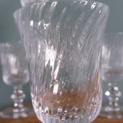Ancient footed crystal glasses with relief twisted fluted goblets.