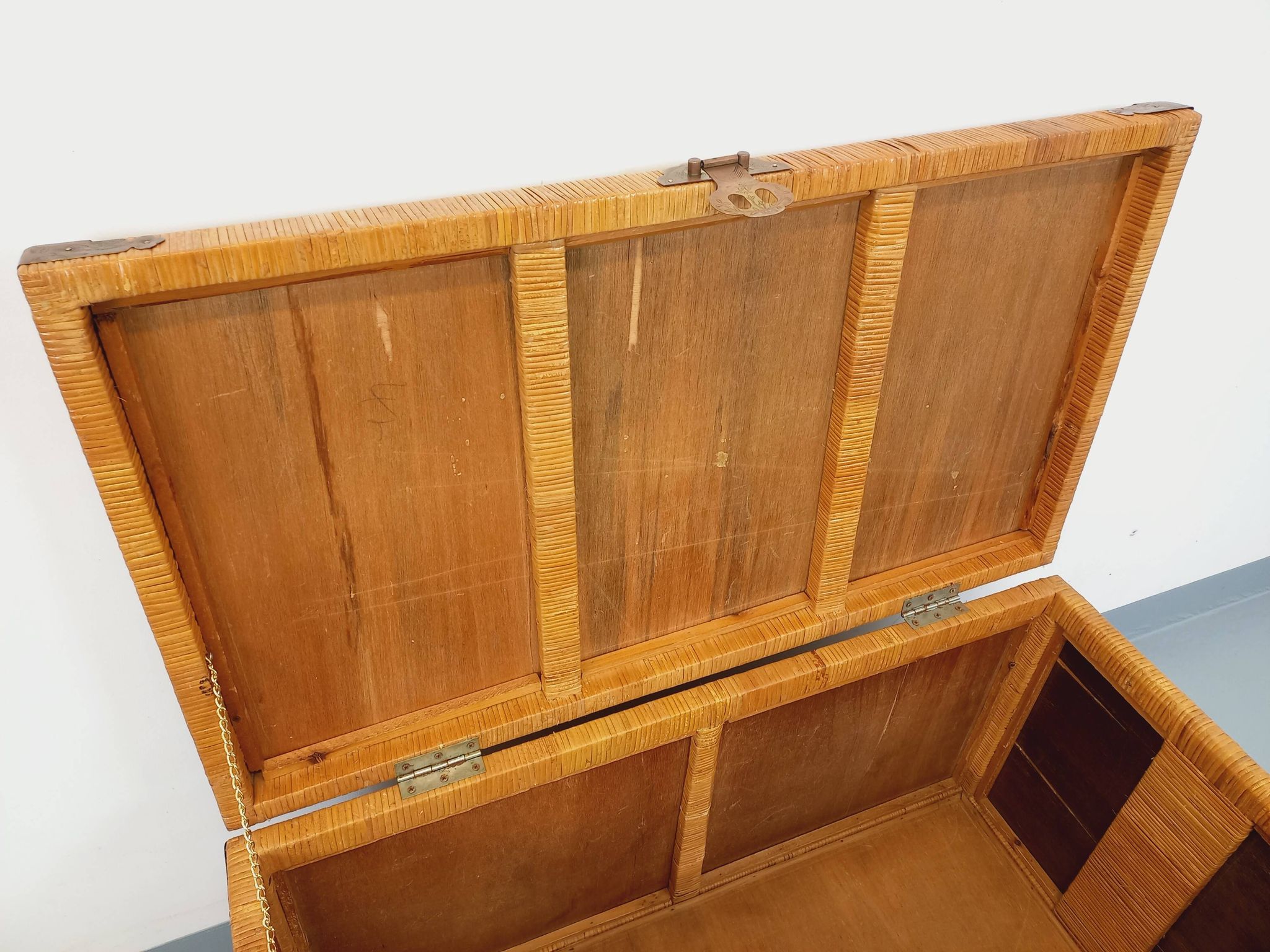 Vintage trunk in wood, rattan, caning, and brass.