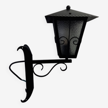 Vintage outdoor lantern and its wrought iron stem