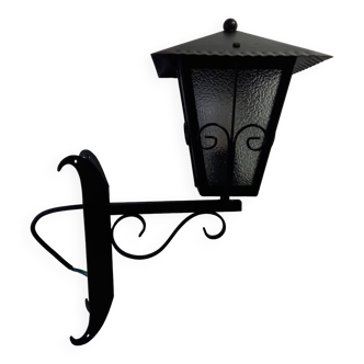 Vintage outdoor lantern and its wrought iron stem