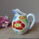Old small jug, handmade ceramic milk pot with hand-painted floral decoration in the Vallauris style.