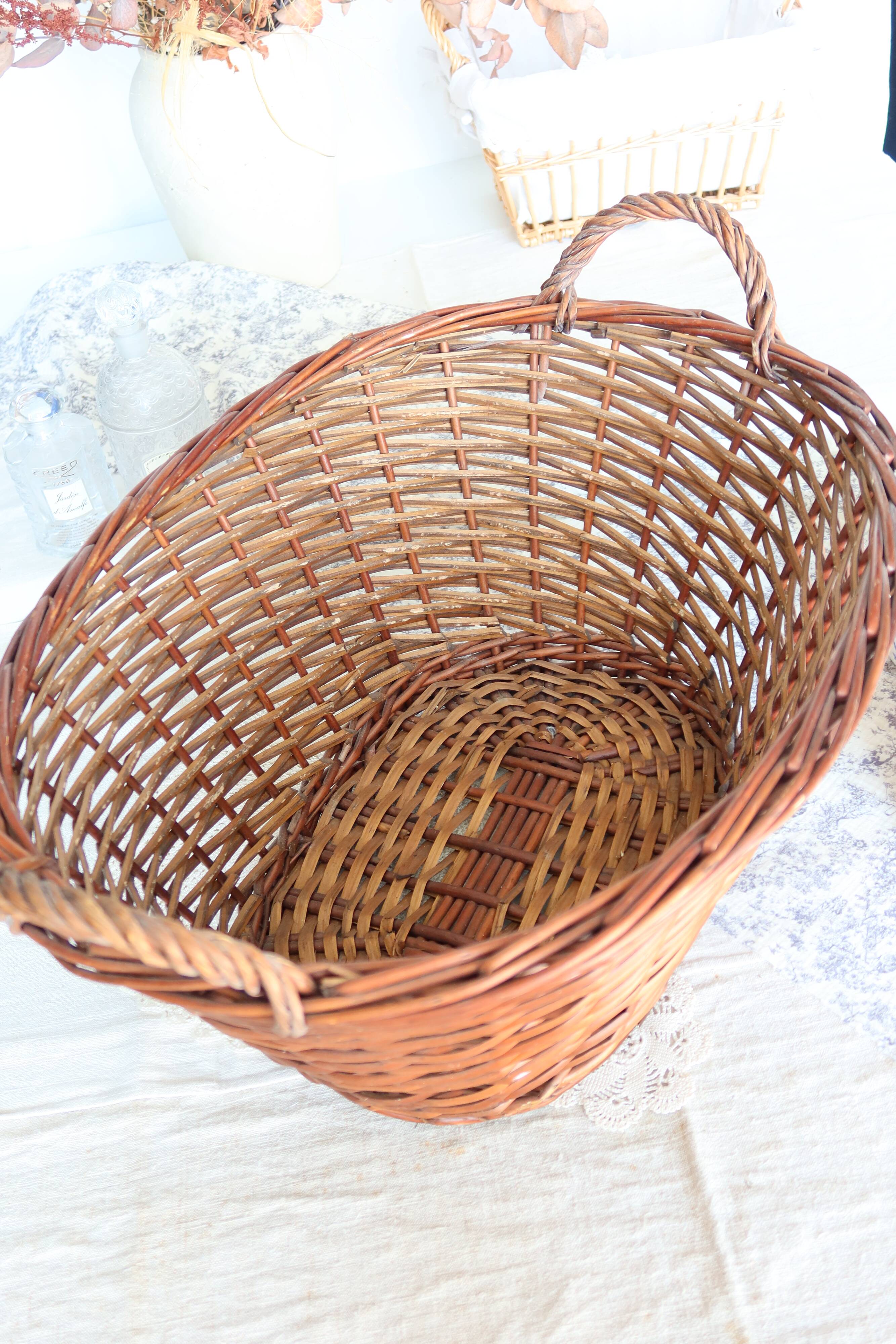 Large vintage dark wicker basket with handles