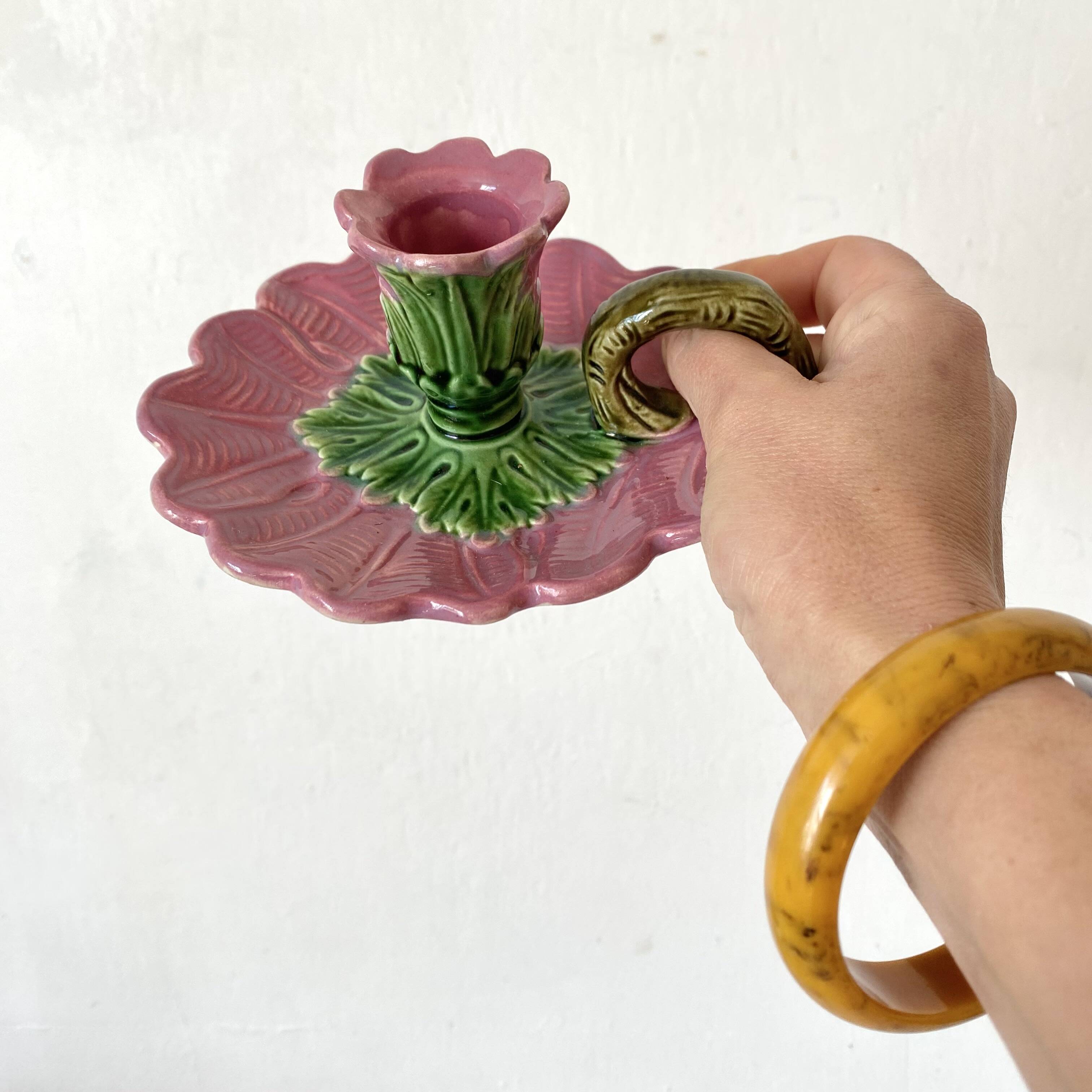 Antique slip candlestick depicting a flower