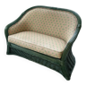 Green wicker bench and floral pattern