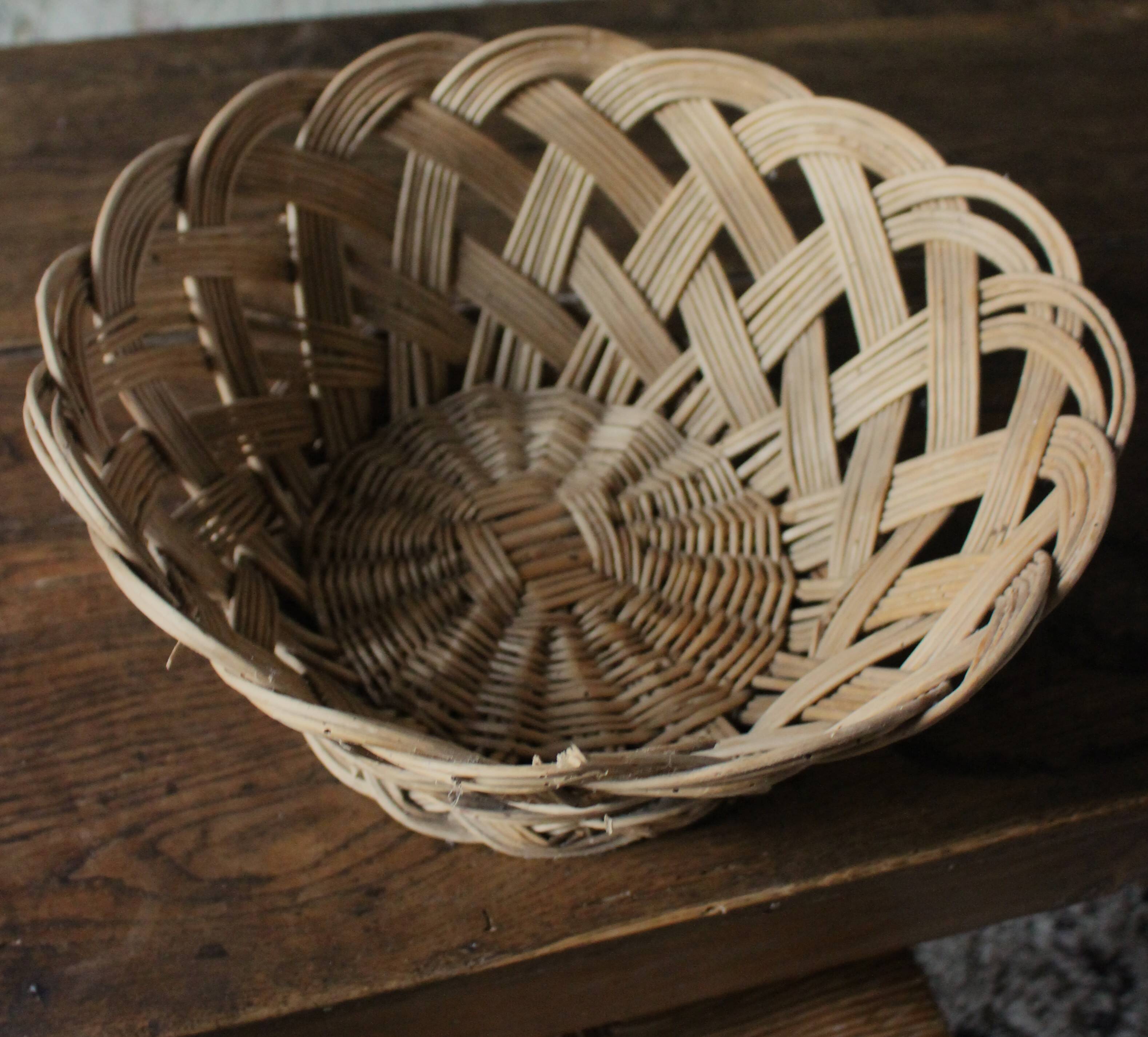 Large vintage twisted wicker basket on a stand