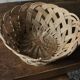 Large vintage twisted wicker basket on a stand