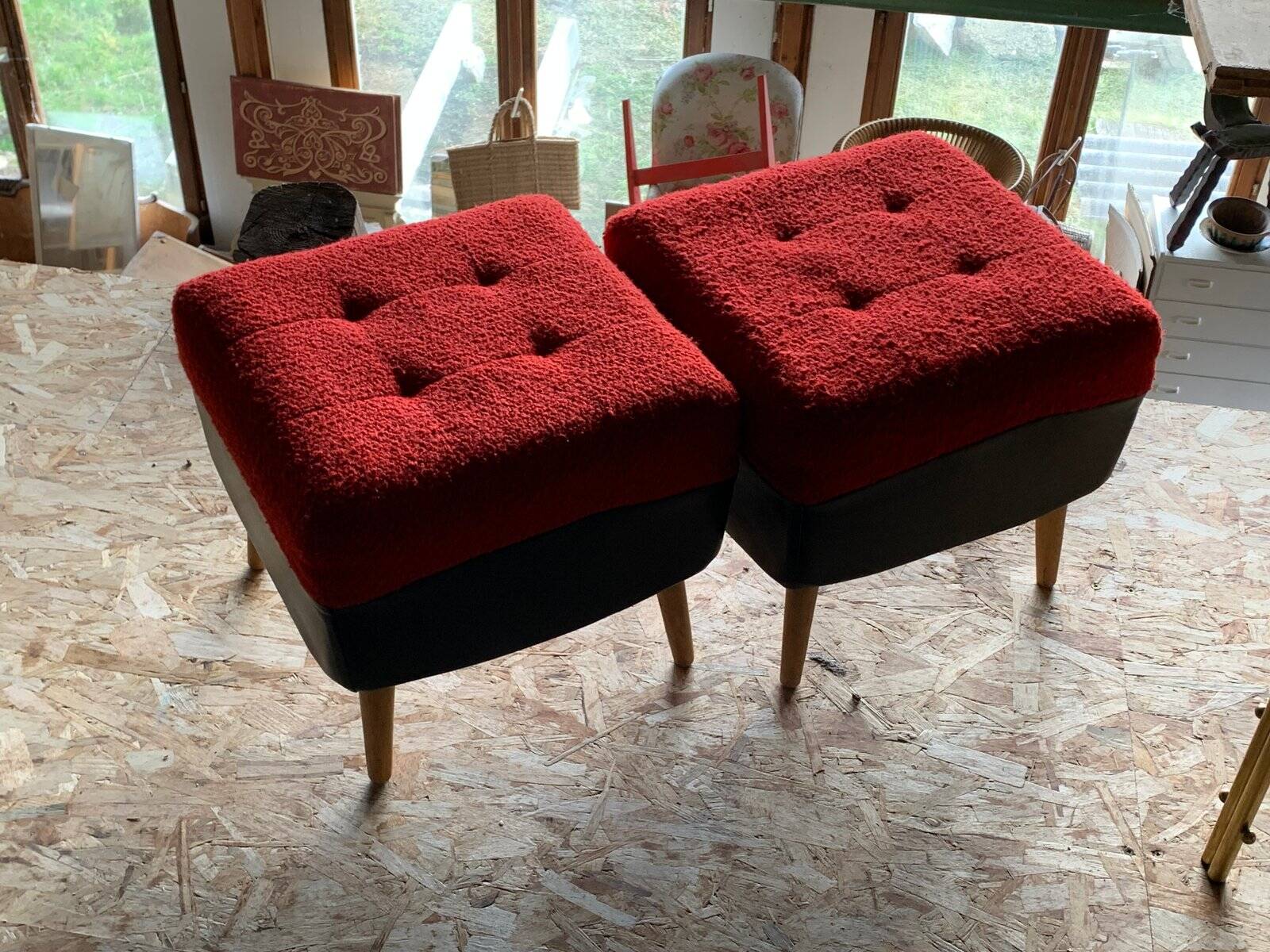 Set of 2 mid-century stools in red and black fabric and faux leather, with light wood legs.