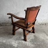 Brutalist dark brown solid wood armchair with natural rattan seat and cognac leather back