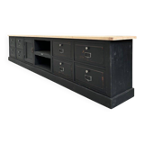 Old workshop furniture transformed into a TV unit.