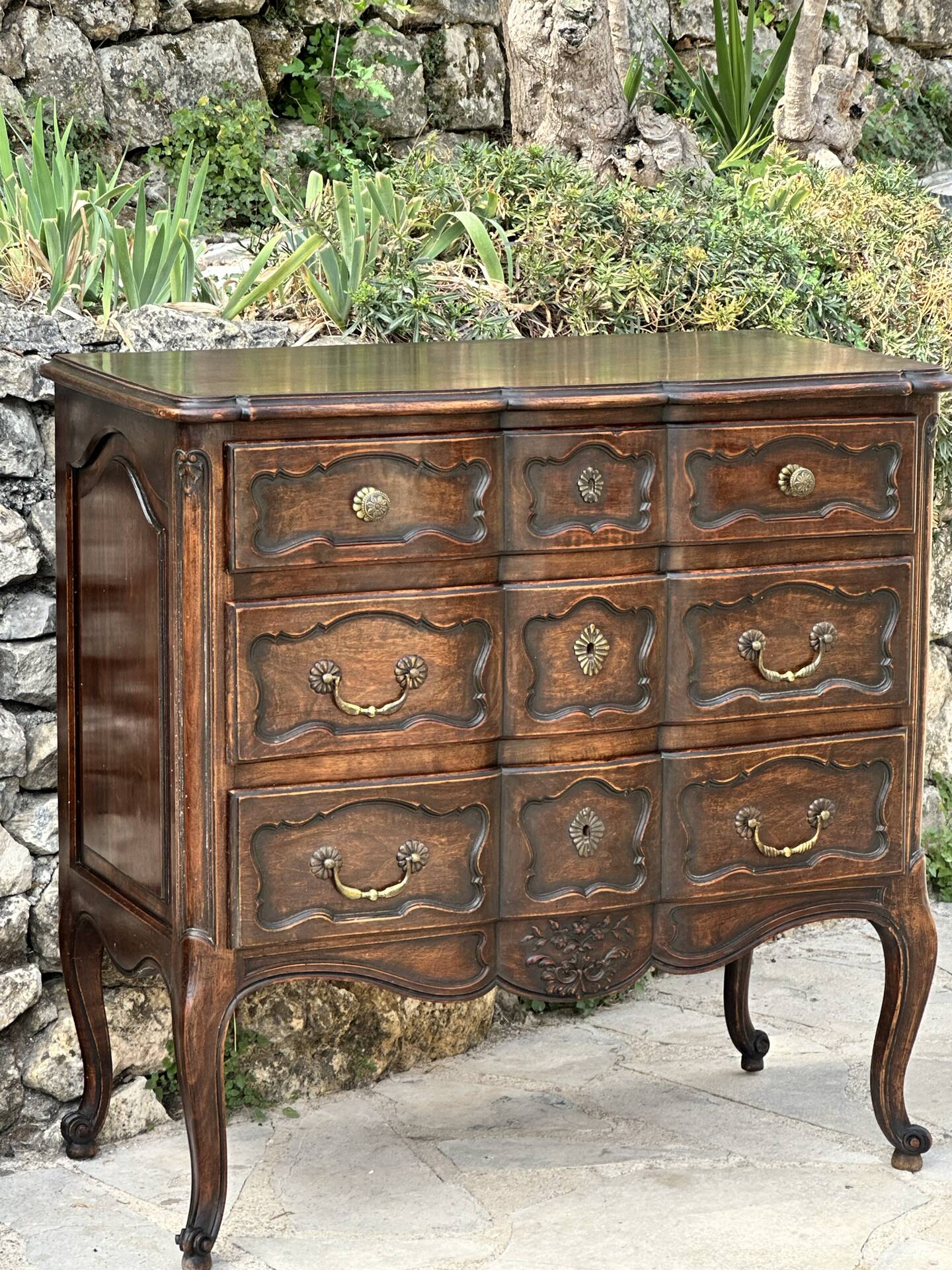 Carved and moulded solid wood commode in the Louis XV style.