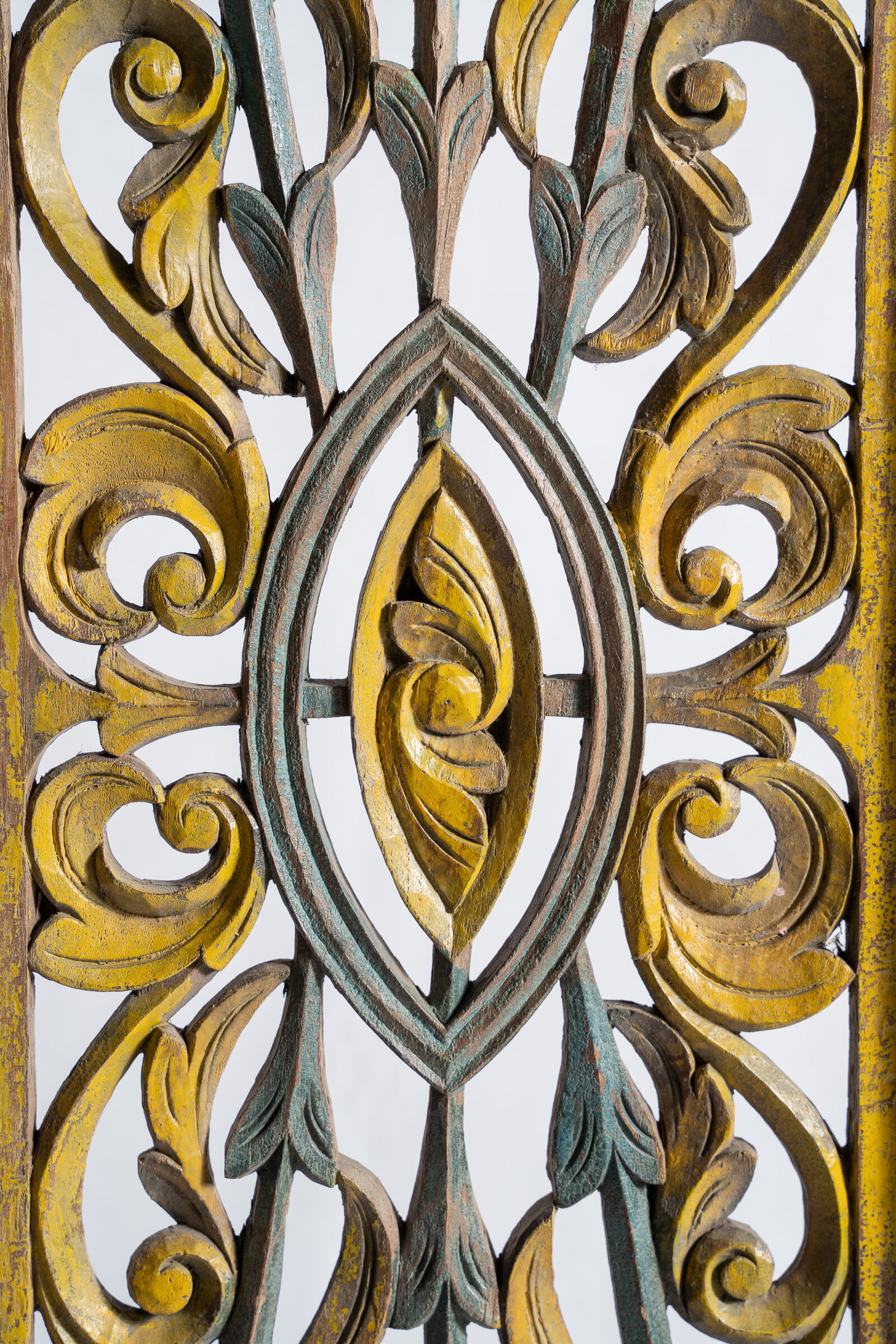 Rectangular Indonesian construction element with blue and yellow plant in carved wood