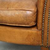Beautiful and comfortable sheepskin armchair, finished with decorative nailheads