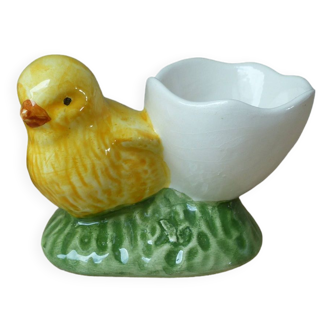 Old egg cup in the shape of a yellow ceramic chick