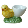 Old egg cup in the shape of a yellow ceramic chick