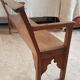 Church bench in fir tree with armrests