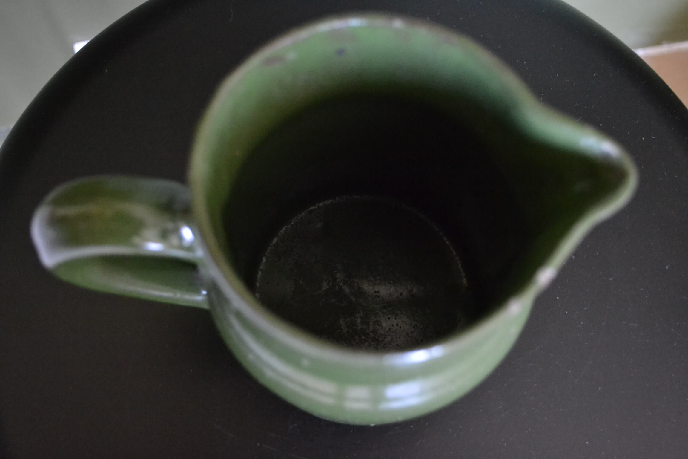 Green pitcher in sandstone