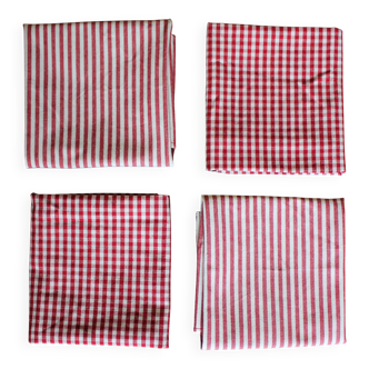 A set of 4 red striped and checkered napkins.