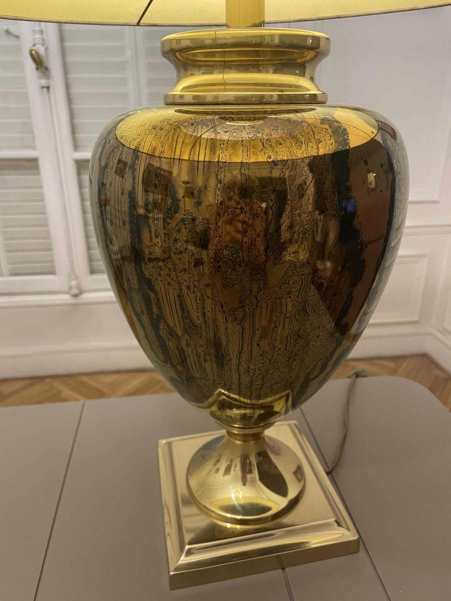 Bronze table lamp with a golden shade.