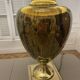 Bronze table lamp with a golden shade.