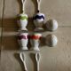 Set of 4 egg cups with their spoons, salt shaker, colored pepper shaker