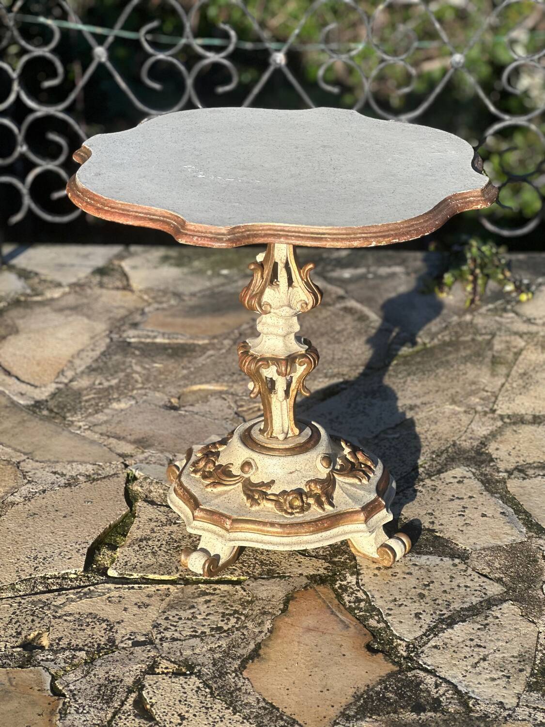 Carved and lacquered wooden side table.