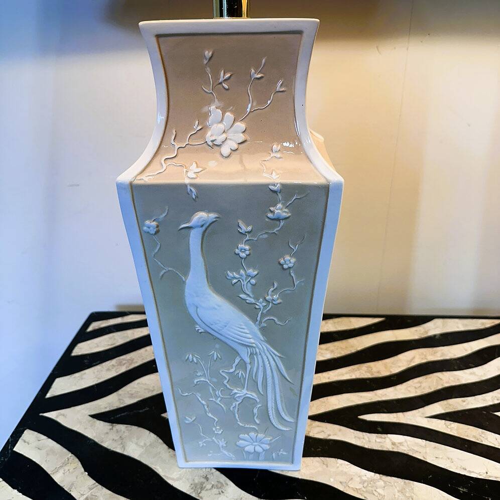 Pair of large cream ceramic table lamps with relief peacocks and fabric shades