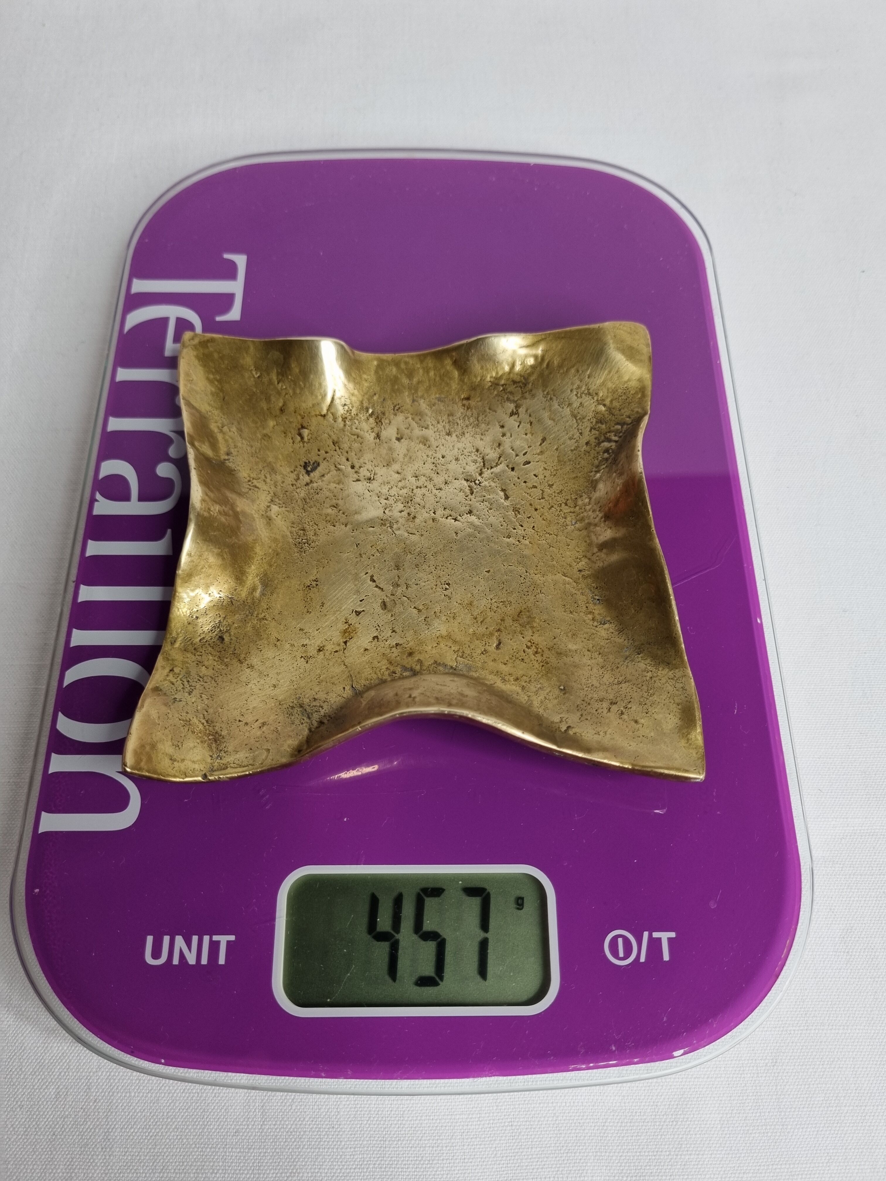 Empty pocket in polished brass representing a crumpled paper, signed CJ, 11.5 cm