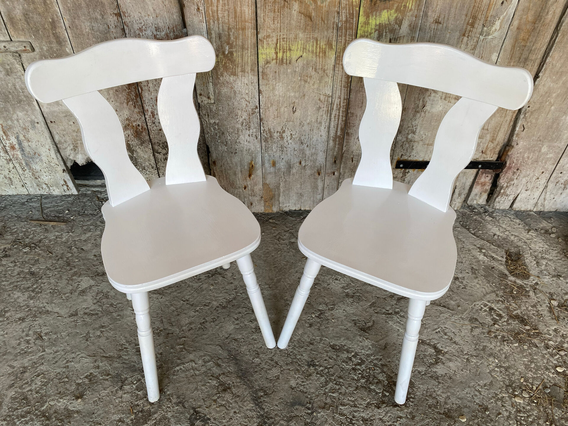 Pair of vintage white wooden bistro chairs