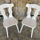 Pair of vintage white wooden bistro chairs