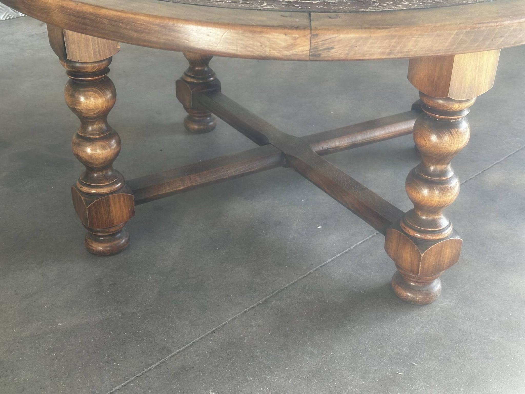 Vintage wooden turned coffee table with leather and astrological decoration.